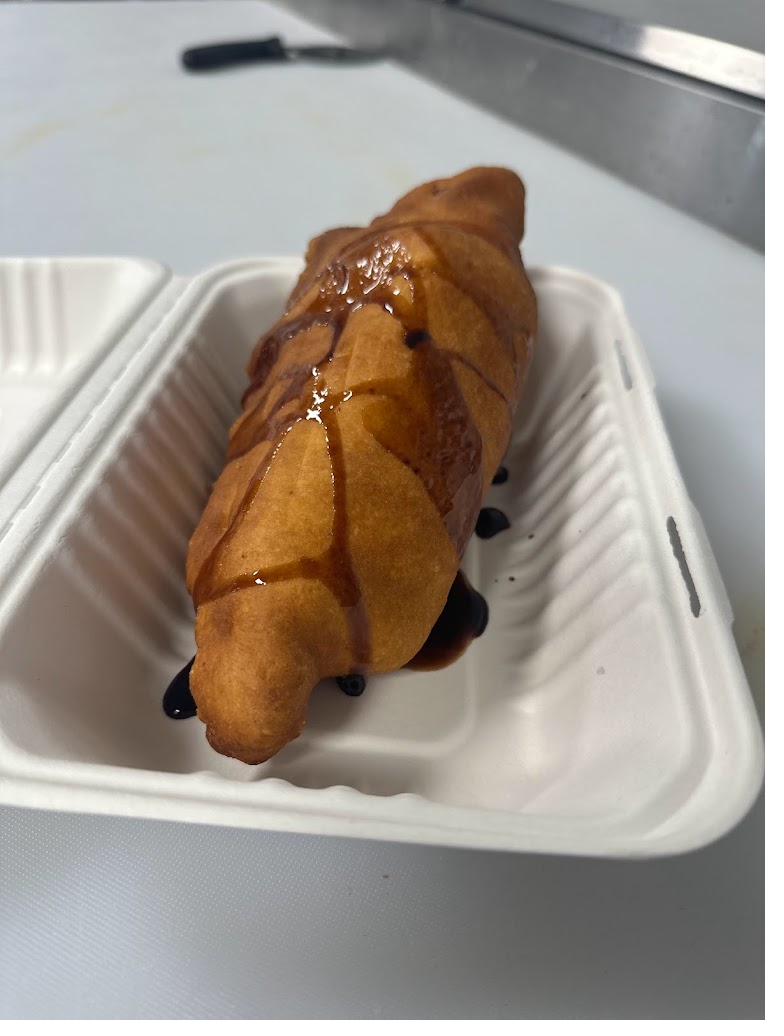 Golden fried panzerotti drizzled with sauce
