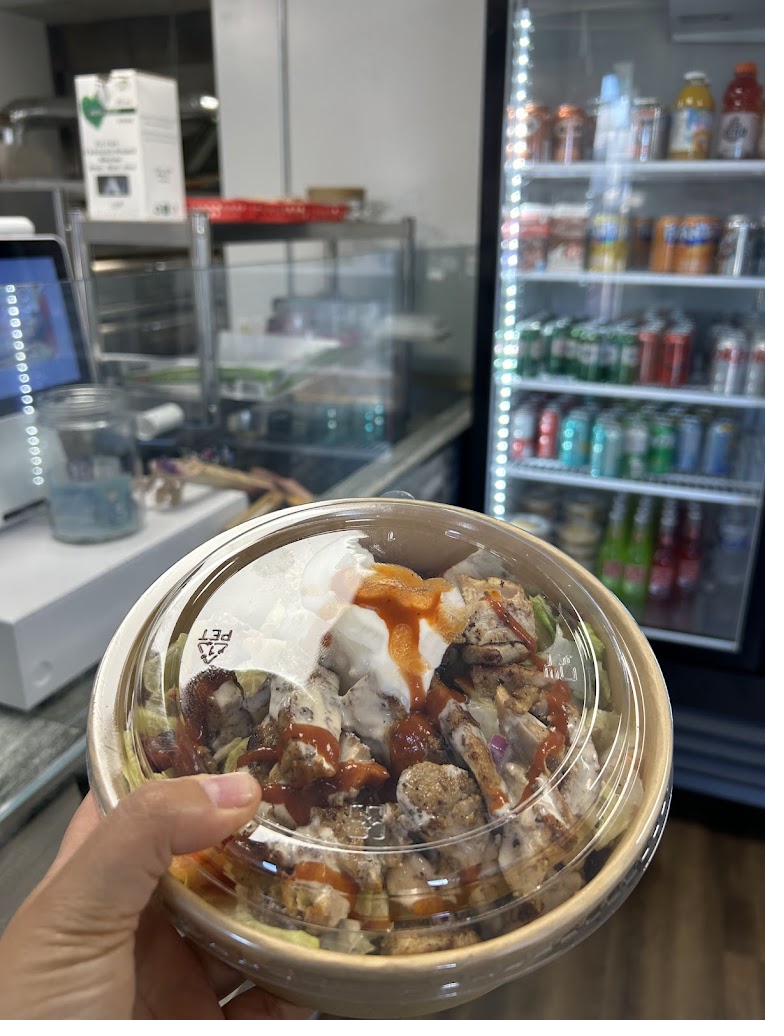Chicken shawarma bowl with garlic sauce and hot sauce