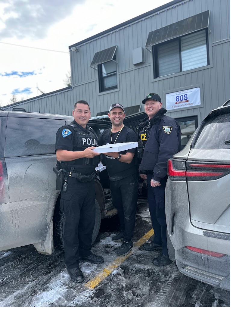 80's Pizza & Grill owner delivering pizza to local Delaware police officers